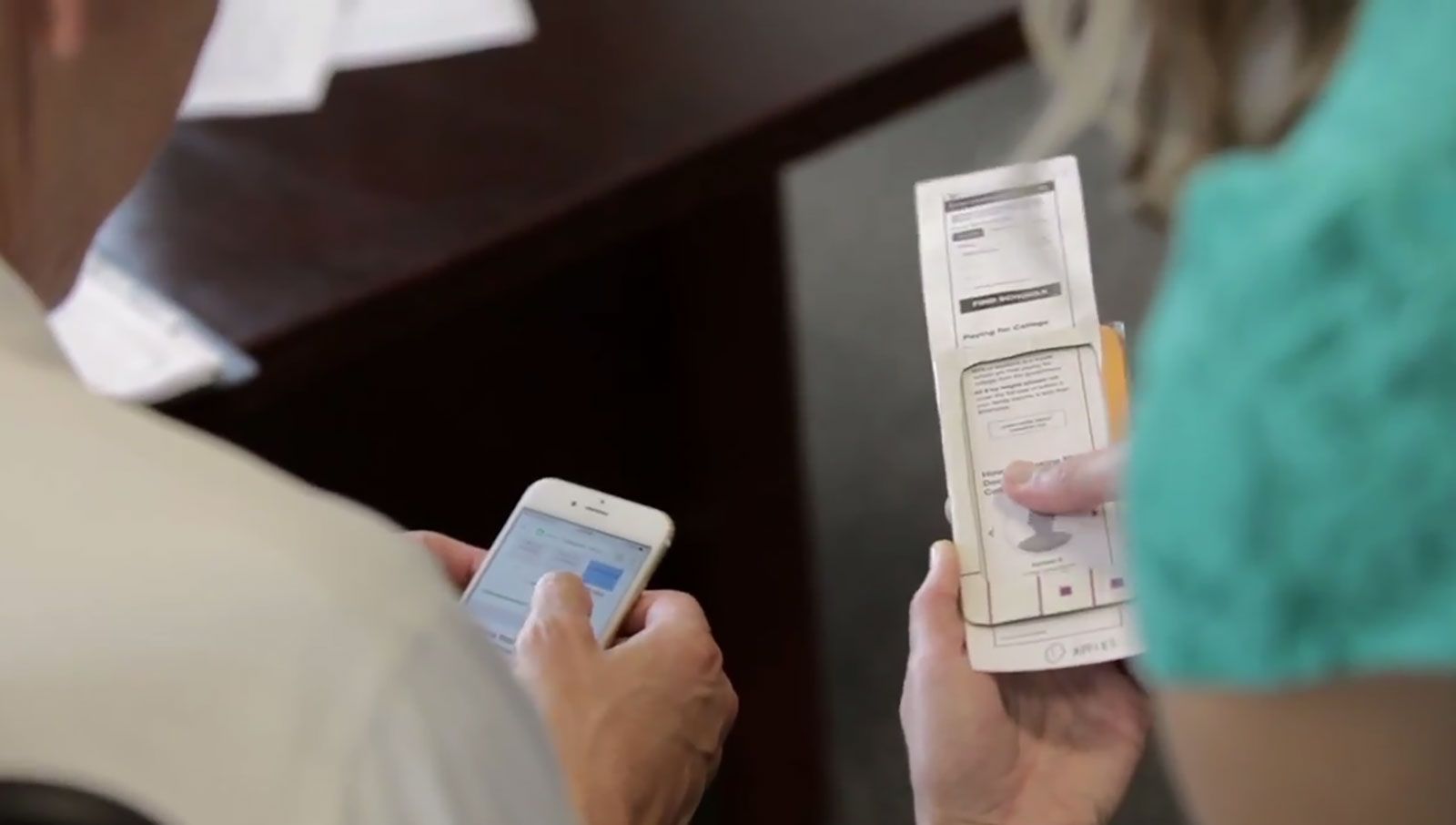 Secretary of Education Arne Duncan sees the difference between the paper prototype and the mobile-friendly version of the College Scorecard.